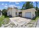 Rear exterior view featuring a detached garage and paved parking area at 4435 1St S Ave, St Petersburg, FL 33711