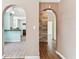 Hallway view showing the kitchen and living areas with arched entryways, offering a glimpse into the home's layout at 4435 1St S Ave, St Petersburg, FL 33711