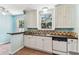 The kitchen has tile flooring, white cabinetry, and standard appliances at 4435 1St S Ave, St Petersburg, FL 33711