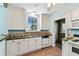 The kitchen features white cabinets, tiled countertops, and standard appliances at 4435 1St S Ave, St Petersburg, FL 33711