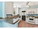 The kitchen is equipped with white appliances and cabinetry, light blue walls, and tile flooring at 4435 1St S Ave, St Petersburg, FL 33711