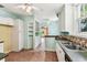 The kitchen features white cabinetry and hardware, as well as tile flooring at 4435 1St S Ave, St Petersburg, FL 33711
