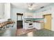 The kitchen features white cabinets, tiled flooring, and standard appliances at 4435 1St S Ave, St Petersburg, FL 33711