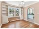 Living room with built-in shelving and hardwood floors leading into an archway of an adjoining room at 4435 1St S Ave, St Petersburg, FL 33711