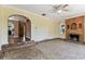 Spacious living room with unique tile flooring, a decorative fireplace, and arched entryways, enhancing its charm at 4435 1St S Ave, St Petersburg, FL 33711