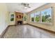 Sunlit living room featuring vintage fireplace and a wall of windows that offer lovely outdoor views at 4435 1St S Ave, St Petersburg, FL 33711
