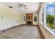 Bright living room with a fireplace and expansive windows offering a view of the lush greenery outside at 4435 1St S Ave, St Petersburg, FL 33711
