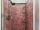 Bathroom shower stall with pink tile and metal caddy at 4435 1St S Ave, St Petersburg, FL 33711