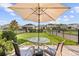 Cozy backyard with patio table and chairs, a manicured lawn, and black metal fencing at 4465 Tubular Run, Land O Lakes, FL 34638