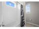 Bright bathroom featuring a white tiled tub and shower combination and natural light at 4465 Tubular Run, Land O Lakes, FL 34638