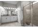 Modern bathroom with double vanity, granite countertops, tiled walk-in shower, and neutral color palette at 4465 Tubular Run, Land O Lakes, FL 34638