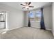 Bright bedroom features plush carpet, ceiling fan, and natural light from two windows at 4465 Tubular Run, Land O Lakes, FL 34638