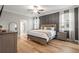 Serene bedroom featuring a king-size bed, modern decor, and an adjacent bathroom entrance at 4465 Tubular Run, Land O Lakes, FL 34638