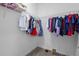 Walk-in closet with wire shelving filled with clothes and shoes, and a carpet floor at 4465 Tubular Run, Land O Lakes, FL 34638