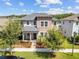 Two-story home featuring a welcoming front porch and manicured landscaping at 4465 Tubular Run, Land O Lakes, FL 34638