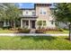 Charming two-story home with well-maintained landscaping, including mature trees, shrubs, and a inviting front porch at 4465 Tubular Run, Land O Lakes, FL 34638