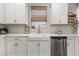 Stylish kitchen featuring white cabinets, a farmhouse sink, and modern stainless steel appliances at 4465 Tubular Run, Land O Lakes, FL 34638