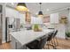 Modern kitchen featuring white cabinetry, stainless steel appliances, and a central island with seating at 4465 Tubular Run, Land O Lakes, FL 34638