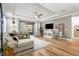 Cozy living room with wood floors, recessed lights, and a sliding glass door leading to the outdoors at 4465 Tubular Run, Land O Lakes, FL 34638