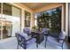 Relaxing covered patio with comfortable seating area around a modern fire pit table at 4465 Tubular Run, Land O Lakes, FL 34638