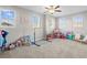 Spacious playroom with carpet flooring, lots of natural light, and furnished with a variety of toys at 4465 Tubular Run, Land O Lakes, FL 34638