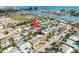 Expansive aerial view of a waterfront home with mature landscaping, close to the bay with nearby community features at 463 85Th Ave, St Pete Beach, FL 33706