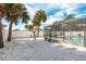 This backyard features white gravel, palm trees, and an enclosed swimming pool at 463 85Th Ave, St Pete Beach, FL 33706
