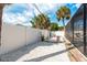 This backyard features white gravel, a white fence, palm trees, and an enclosed swimming pool at 463 85Th Ave, St Pete Beach, FL 33706