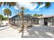 This backyard features white gravel, palm trees and an enclosed swimming pool at 463 85Th Ave, St Pete Beach, FL 33706