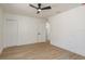 This bedroom features light wood floors, white walls, a closet and a ceiling fan at 463 85Th Ave, St Pete Beach, FL 33706