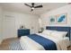 This bedroom features a ceiling fan, white walls, a blue dresser and blue and white decor at 463 85Th Ave, St Pete Beach, FL 33706