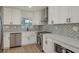 Bright, updated kitchen with white cabinets, quartz countertops, and stainless steel appliances at 463 85Th Ave, St Pete Beach, FL 33706