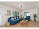 Cozy living room with a blue sofa, natural light, and modern decor creating a comfortable atmosphere at 463 85Th Ave, St Pete Beach, FL 33706