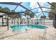 This home features an in-ground pool under a large screened enclosure and a stone paver pool deck at 463 85Th Ave, St Pete Beach, FL 33706