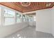 Bright sunroom with wood plank ceiling, patterned tile floor, and views of the outdoors at 463 85Th Ave, St Pete Beach, FL 33706