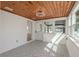 Inviting sunroom with plank ceiling, tile floor, ample natural light, and access to the outdoors at 463 85Th Ave, St Pete Beach, FL 33706