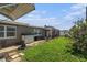 A shot of the backyard with green grass, a patio and an outdoor storage box at 5128 Billings Dr, Holiday, FL 34690