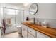 Stylish bathroom with wood countertop, modern vanity, and glass enclosed shower at 5128 Billings Dr, Holiday, FL 34690