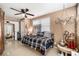 Comfortable bedroom featuring a ceiling fan, neutral walls, and natural light through the large window at 5128 Billings Dr, Holiday, FL 34690