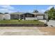Charming single-story home featuring a screened porch, landscaped yard, and a one-car garage at 5128 Billings Dr, Holiday, FL 34690