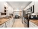 Functional kitchen with white cabinetry, granite countertops, and stainless steel appliances at 5128 Billings Dr, Holiday, FL 34690