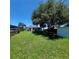 Green backyard featuring well-maintained lawn, shed, and shade trees for relaxing at 5627 Commonwealth N Ave, St Petersburg, FL 33703