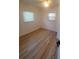 Cozy bedroom featuring wood-look flooring, natural light, and ample closet space at 5627 Commonwealth N Ave, St Petersburg, FL 33703