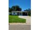 Charming single-story home featuring a welcoming front yard and convenient carport at 5627 Commonwealth N Ave, St Petersburg, FL 33703