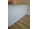 Elegant kitchen island with granite countertop, shiplap detail and wood flooring at 5627 Commonwealth N Ave, St Petersburg, FL 33703