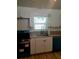 Modern kitchen featuring granite countertops, updated cabinetry, and a stainless steel sink at 5627 Commonwealth N Ave, St Petersburg, FL 33703