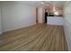 Bright and airy living room featuring wood-look flooring and a seamless flow to the kitchen at 5627 Commonwealth N Ave, St Petersburg, FL 33703