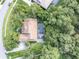 Aerial view of a house featuring a screened-in pool and lush landscaping at 5927 Flatwoods Manor Cir, Lithia, FL 33547