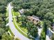Stunning aerial view of home with mature trees, lush landscaping, long driveway, and private pool at 5927 Flatwoods Manor Cir, Lithia, FL 33547