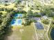 Aerial view of community amenities featuring tennis courts, a basketball court, and open green space at 5927 Flatwoods Manor Cir, Lithia, FL 33547